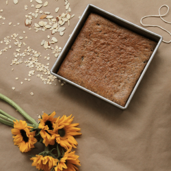 tom's sun bars in the square tin pan to bake